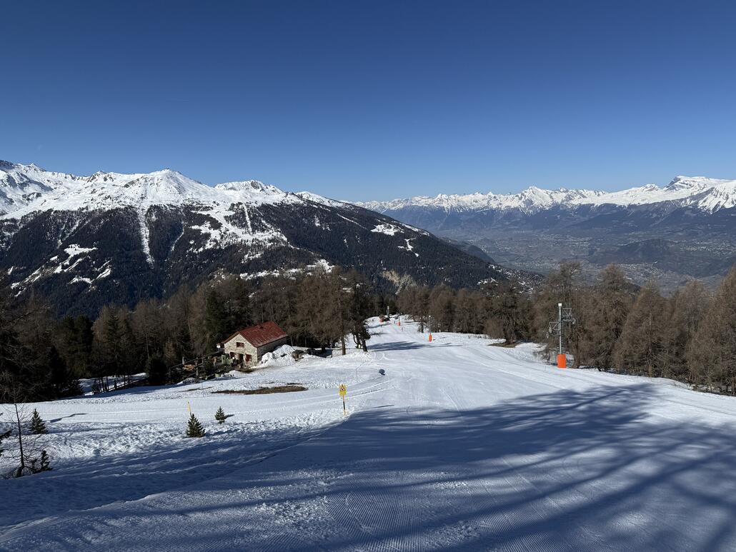 Untere Teil der rote Illhornpiste mit Blick auf der dazugehörige Skihütte «Cabane Illhorn»