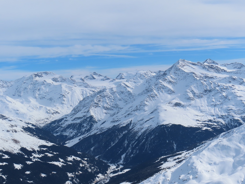 Links vom Pizzo Tresero ist die Punta Taviela, dann der Monte Vioz (höchster Wanderberg der Ostalpen, die wanderbare Route ist aber auf der Rückseite) und Palon della Mare. Diese Berge umranden einen der größten Ostalpengletscher, den Ghiacciaio dei Forni. Ein Teil des Gletschers ist im Bild zu sehen, der weitaus größere Teil bleibt allerdings verborgen. Links außerhalb des Bilfausschnitts wäre dann der Cevedale.