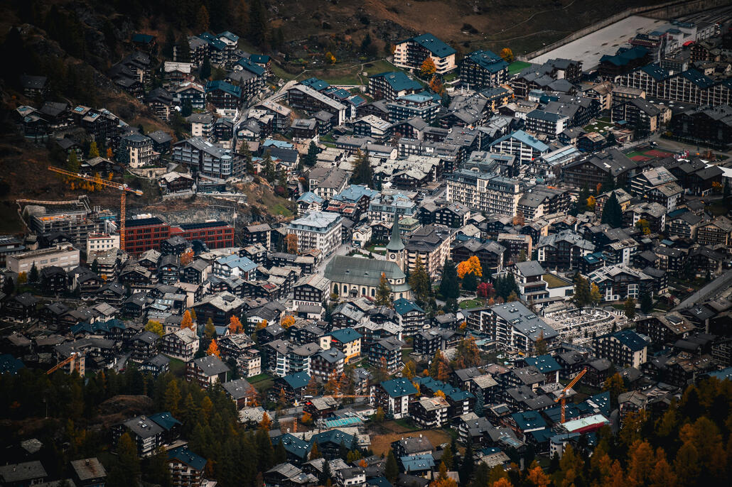 das dorfzentrum mit dem kirchplatz. oben rechts der bahnhof links die schulhäuser mit dem 55 milionen teuren neubau der primarstufe
